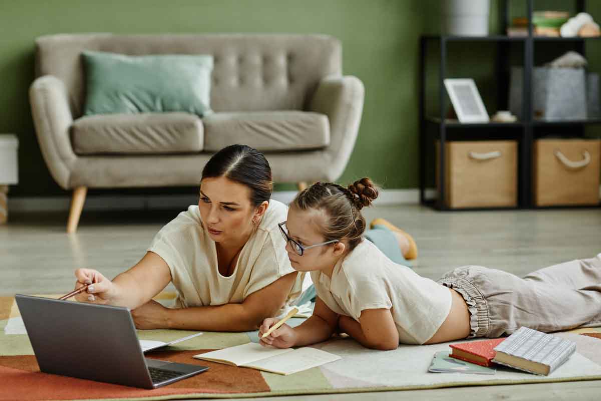 girl-studying-with-mom-on-floor