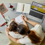 girl-studying-with-mom-top-view