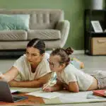 Girl with Down Syndrome Studying with Mom on Floor